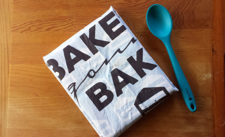 Cookbook gift wrapped with Bakers Gonna Bake tea towel by Lellobird